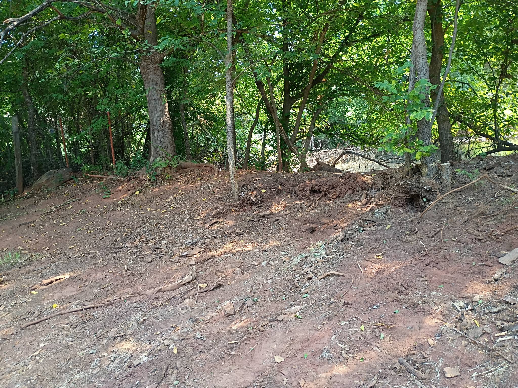 Same fence line cleared and graded